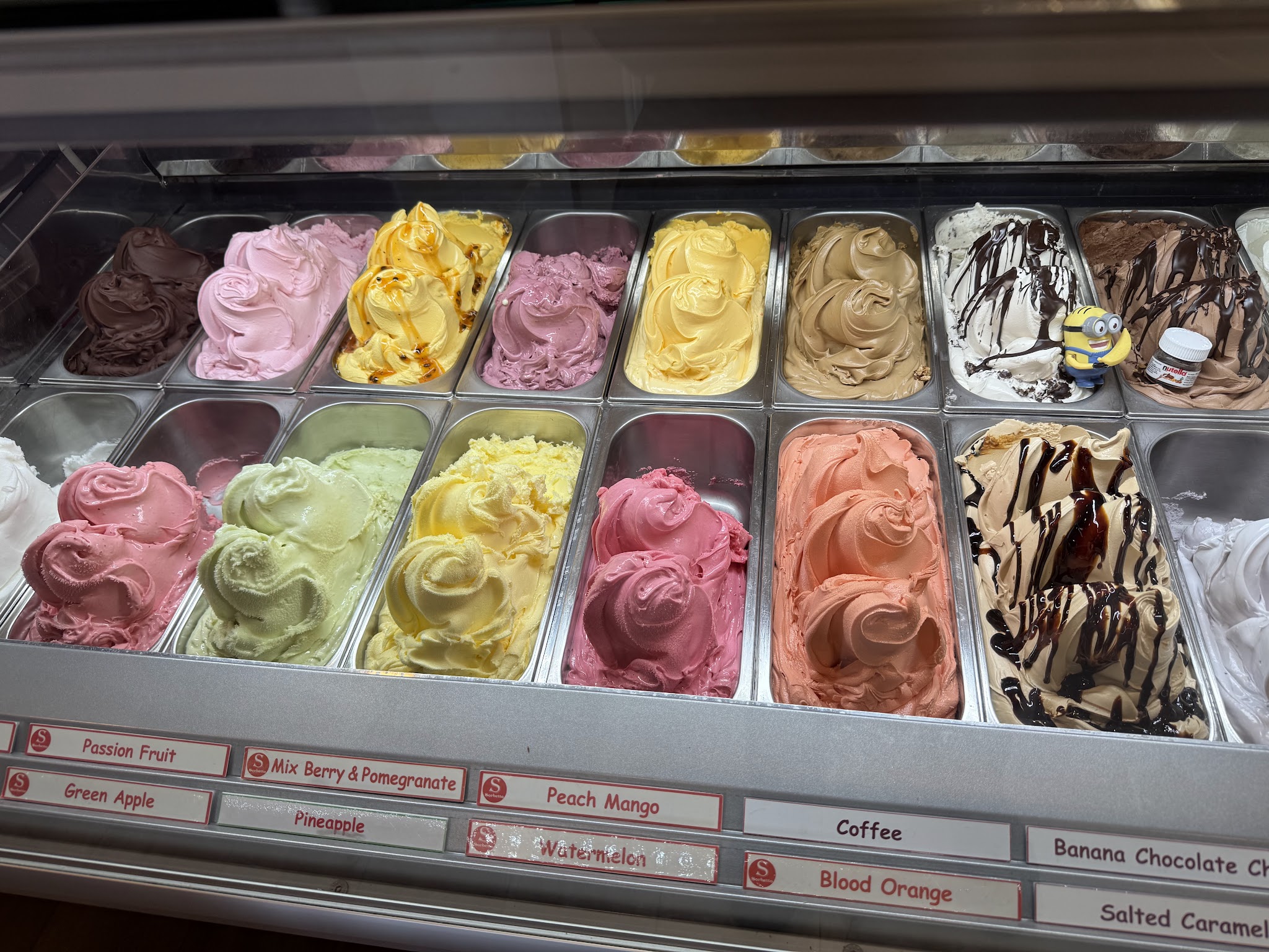Colorful fruit gelato and sorbetto flavors including Passion Fruit, Blood Orange, and Peach Mango